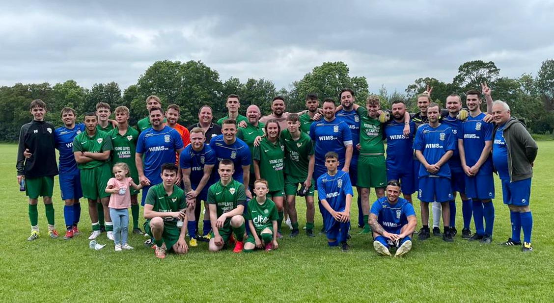 Group of football players pose for a photo